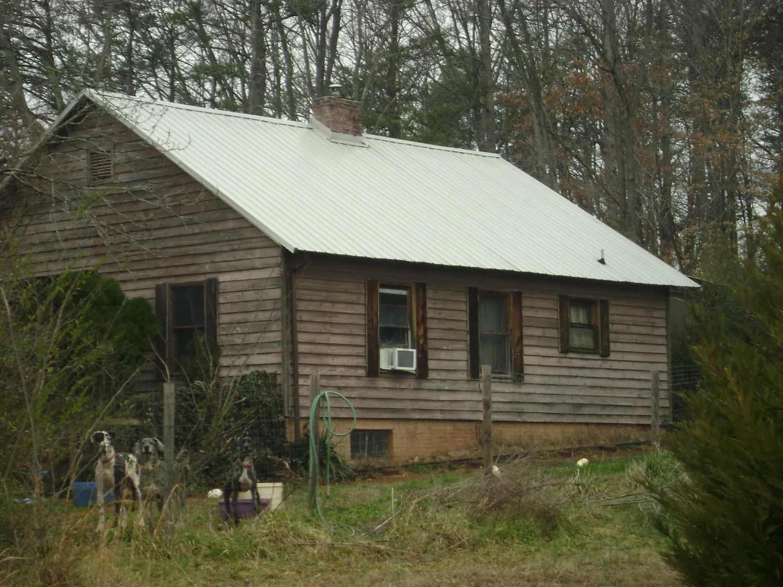 White metal roof on an old wood sided farmhouse, from a Metal Roof Installation job in La Valle